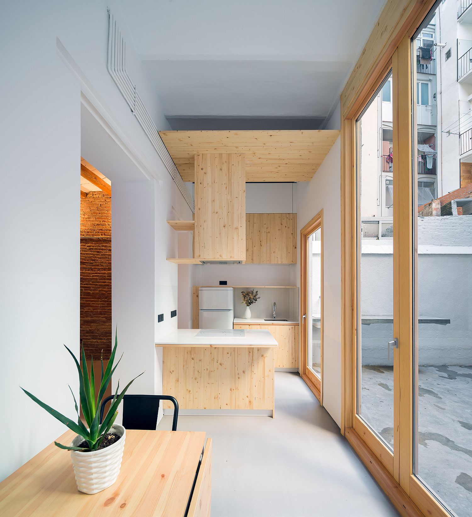 Exquisite-and-space-savvy-tiny-kitchen-in-white-and-wood